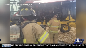 Two firefighters looking at tractor