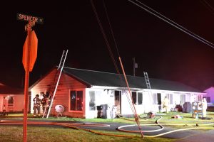 Home with fire equipment around it