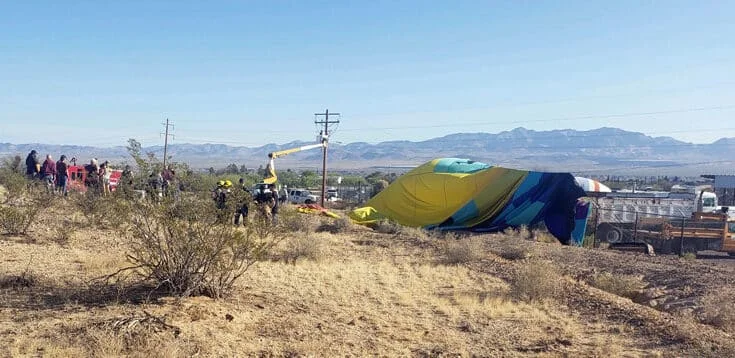 hot air balloon draped over utility wires